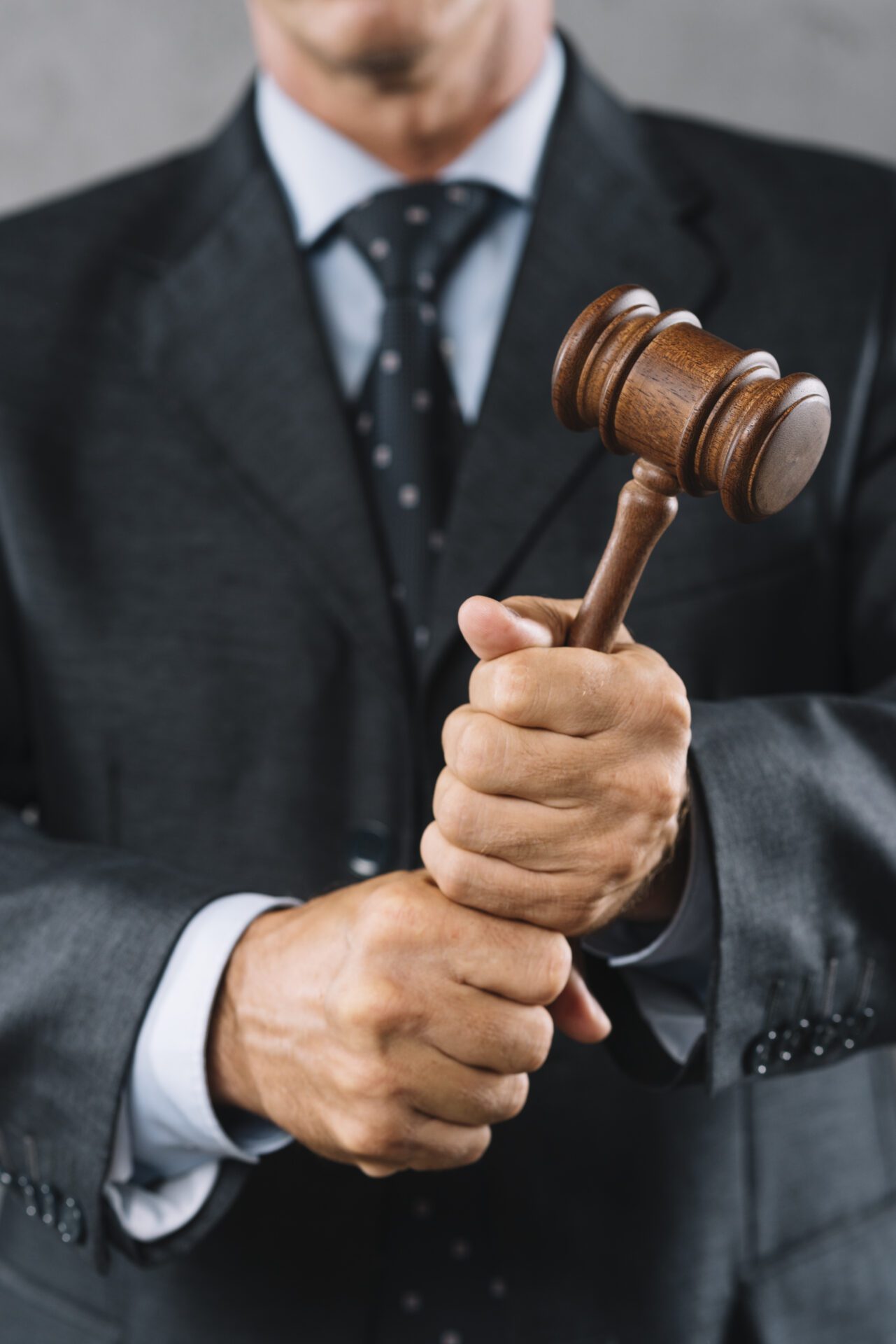 mid section male lawyer holding wooden mallet hand